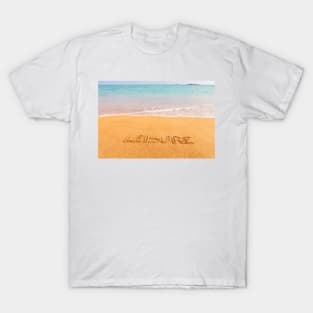 Inscription "LEISURE" made on beautiful beach by the blue sea T-Shirt